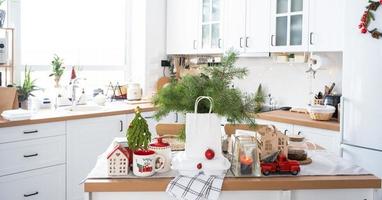 Food delivery service containers on table in white kitchen, festively served for celebration of Christmas and new year.  Saving time, hot order, disposable plastic box, craft package. mock up photo