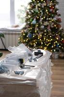 Building materials with tools for home repair on the background of a Christmas tree - decorative repairs and construction for the new year photo