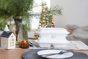 Food delivery service containers on table in white kitchen, festively served for celebration of Christmas and new year.  Saving time, hot order, disposable plastic box, craft package. mock up photo