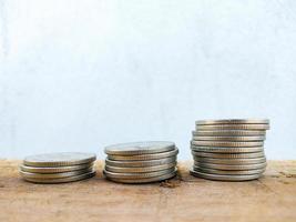 coins stacked on wooden table blurred background bank finance economics business design template photo