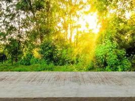 empty brown wooden table  Nature background, morning sun  product presentation design template shop advertisement photo