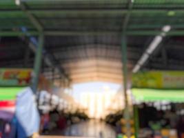 Blurred image of a wholesale and retail market with a large roof in the morning. photo