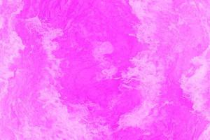 Defocus blurred transparent purple colored clear calm water surface texture with splashes and bubbles. Trendy abstract nature background. Water waves in sunlight with copy space. Pink water drop shine photo