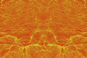 Defocus blurred transparent orange colored clear calm water surface texture with splashes and bubbles. Trendy abstract nature background. Water waves in sunlight with copy space. Red watercolor shine photo