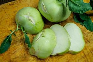 Fresh kohlrabi cutting on wooden board prepare for cooking. Brassica oleracea Gongylodes Group photo