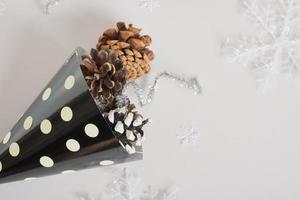 paper homemade party hat and christmas decor on a gray background, postcard copy space for the new year photo