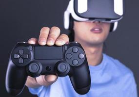 excited man in VR headset looking up and trying to touch objects in virtual reality photo