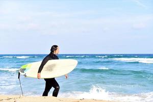 Beautiful sexy surfer girl on the beach photo