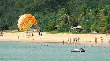 mensen kom tot rust Aan Karon strand. deze is een van de meest populair stranden tussen toeristen in phuket video