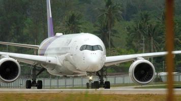 PHUKET, THAILAND NOVEMBER 26, 2017 - Thai Airways Airbus 350 HS THB taxiing after landing, close up of airplane, engine and gear video