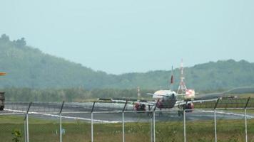 Rear view of the plane that has landed and is taxiing down the runway video