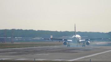 Rear view of a braking aircraft. Airplane landing at the airport, the moment of touching and braking video