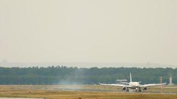 Long shot, the airliner slows down after landing. Smog and haze in the air from the heat at the airport. The plane arrived at the airport video