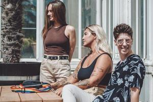 Gay woman smiling and having fun in the park. Same sex young married female couple in their daily routine showing some affection LGBT photo