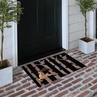 Designer Welcome Entry Doormat Placed on Solid Brick Floor Outside Entry Door with Plants photo