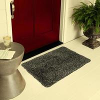 Designer Welcome Entry Doormat Placed on Floor Outside Entry Door with Plants and lemon ice drink photo