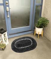 Designer Welcome Entry Doormat Placed Outside Entry Door with Plant and Lamp photo