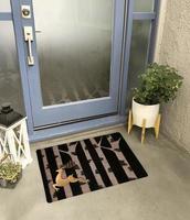 Designer Welcome Entry Doormat Placed Outside Entry Door with Plant and Lamp photo