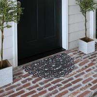 Designer Welcome Entry Doormat Placed on Solid Brick Floor Outside Entry Door with Plants photo