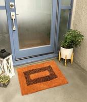 Designer Welcome Entry Doormat Placed Outside Entry Door with Plant and Lamp photo