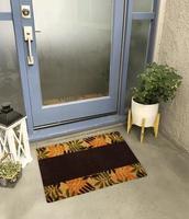 Designer Welcome Entry Doormat Placed Outside Entry Door with Plant and Lamp photo