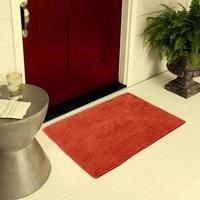 Designer Welcome Entry Doormat Placed on Floor Outside Entry Door with Plants and lemon ice drink photo