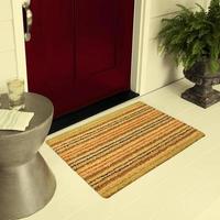 Designer Welcome Entry Doormat Placed on Floor Outside Entry Door with Plants and lemon ice drink photo