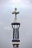 Tile Cross in Park Guell in Barcelona, Spain is a public park system composed of gardens and architectonic elements located on Carmel Hill, in Barcelona, Catalonia. photo