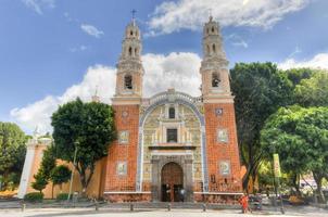 Puebla, Mexico - July 6, 2013 -  The Sanctuary of Our Lady of Guadalupe presents one of the most representative facades of the so-called Baroque Puebla, characterized by the use of tiles and bricks. photo