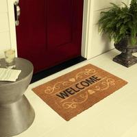 Designer Welcome Entry Doormat Placed on Floor Outside Entry Door with Plants and lemon ice drink photo