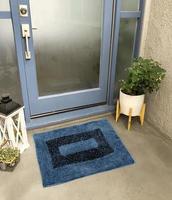 Designer Welcome Entry Doormat Placed Outside Entry Door with Plant and Lamp photo