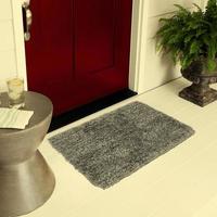 Designer Welcome Entry Doormat Placed on Floor Outside Entry Door with Plants and lemon ice drink photo