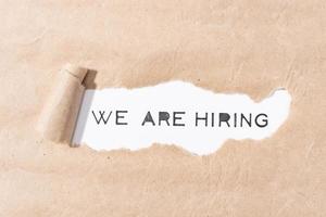 We are Hiring message on torn paper photo