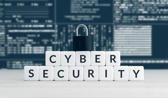 Cyber security words on blocks, closed padlock and computer data screen at background photo