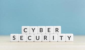 Cyber security concept. Text on cube blocks on blue background. Copy space photo