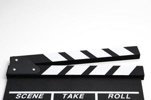 Clapperboard or movie slate black color on white background. Cinema industry, video production and film concept. photo