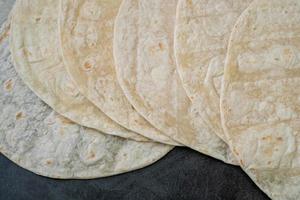 Corn tortillas on black background. Unleavened bread. Mexican tortillas photo