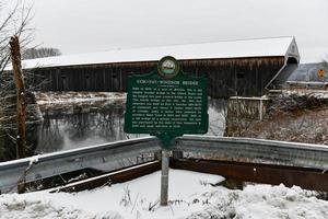 Sign denoting the Cornish-Windsor Covered Bridge. It connects Vermont and New Hampshire at their borders. It is the world's longest covered bridge at 460 feet. It was built in 1866. photo