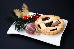 Sweet cake on a plate with Christmas decorations photo