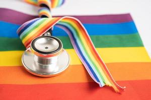 stethoscope on rainbow flag background, symbol of LGBT pride month  celebrate annual in June social, symbol of gay, lesbian, bisexual, transgender, human rights and peace. photo