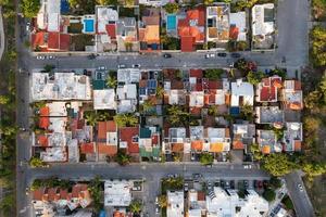 vista aérea de arriba hacia abajo de casas y complejos habitacionales en cancún, méxico. foto