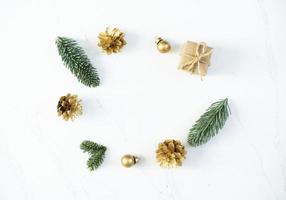 Mockup for a letter or a Christmas invitation with gold fir cone photo