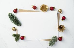 Mockup for a letter or a Christmas invitation with gold fir cone photo