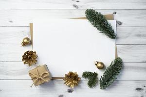 Mockup for a letter or a Christmas invitation with gold fir cone photo