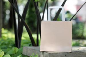 Light brown single paper bag on cement surface in garden photo