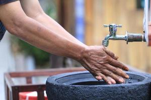 Men's hands were washing their hands in the sink to avoid germs or bacteria photo