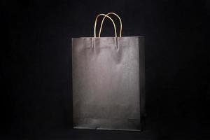 Plain brown paper bag packaging on a black background with copy space photo