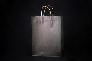 Plain brown paper bag packaging on a black background with copy space photo