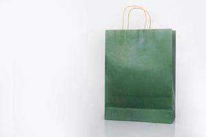 Plain green paper bag packaging on a white background with copy space photo