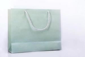 Plain green paper bag. Paper bags for products or merchandise with copy space on white background photo